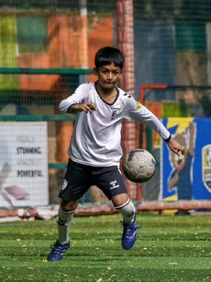 A player demonstrates excellent ball control, trapping the ball mid-air during a competitive training session, showcasing advanced technique.