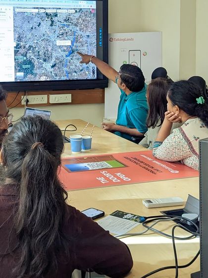 A potential co-farmer gets a detailed overview of a farm location on a large screen. We believe in transparency and providing all the information needed to make an informed decision.