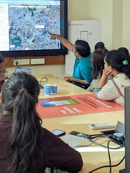 A potential co-farmer gets a detailed overview of a farm location on a large screen. We believe in transparency and providing all the information needed to make an informed decision.