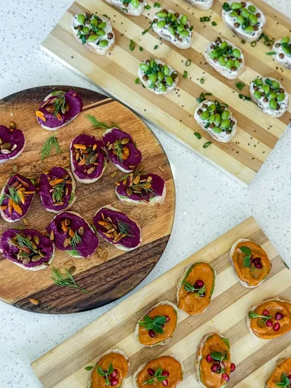 A colorful trio of our signature tartines: beetroot hummus, muhammara, and cream cheese with edamame. A perfect variety for any event.
