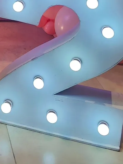 A close-up of the light-up number '2' used in the butterfly-themed birthday party.