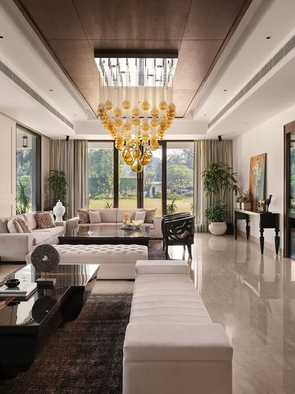 A wider perspective of the Mehalin Farm drawing room, illustrating the scale of the indoor-outdoor connection. The design ensures that from any point in the room, the presence of the green landscape is felt.