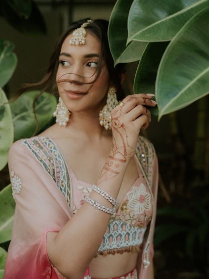 A beautiful candid portrait of the bride during her Haldi ceremony in Mauritius, featured in Vogue India. The wind catching her hair adds a touch of natural movement and grace.