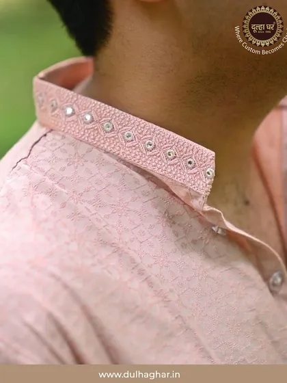 The beauty of my work is in the details. This close-up shows the delicate mirror and thread work on the collar of a pink kurta, a small touch of craftsmanship that makes the entire outfit unique and personal.