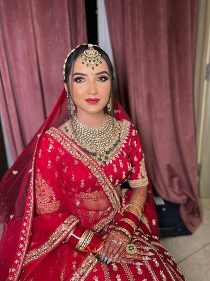 A perfect shot of my bride Gurusha in her stunning red lehenga. The makeup is glamorous yet elegant, with a focus on her beautiful eyes and radiant skin.