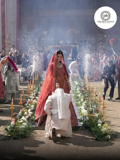 Capturing the joy of the Jaimala ceremony. This moment is enhanced by our stage setup, featuring a flower-lined aisle and cold pyro effects that add a touch of drama and celebration to the bride's entrance.
