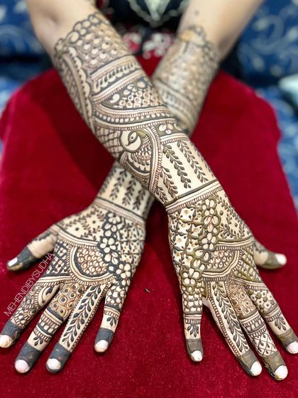 The back of the hands for an engagement, featuring a beautiful and intricate leaf and vine pattern.