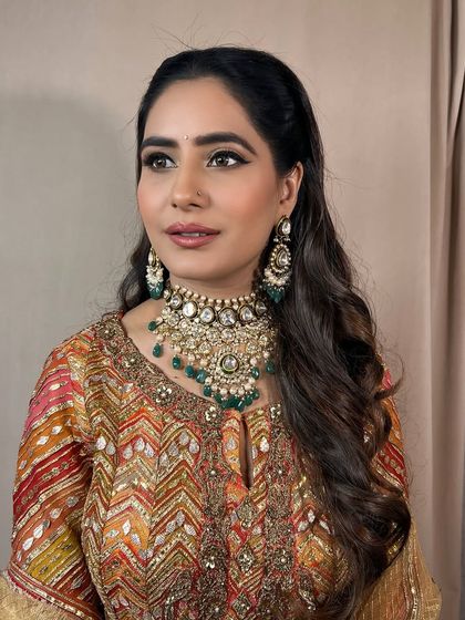 A close-up of a client draped in tradition, with soft glam makeup that enhances her features.