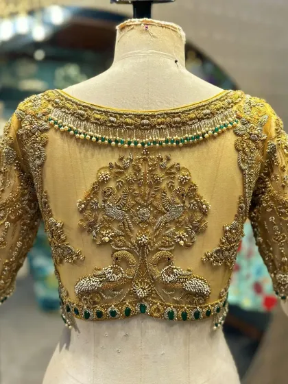 The magic is in the details. This close-up shows the artistry of my karigars, featuring a 'Tree of Life' motif brought to life with zardosi, pearls, and emerald-green beadwork on a sheer net back. Every stitch is a testament to our commitment to craftsmanship.