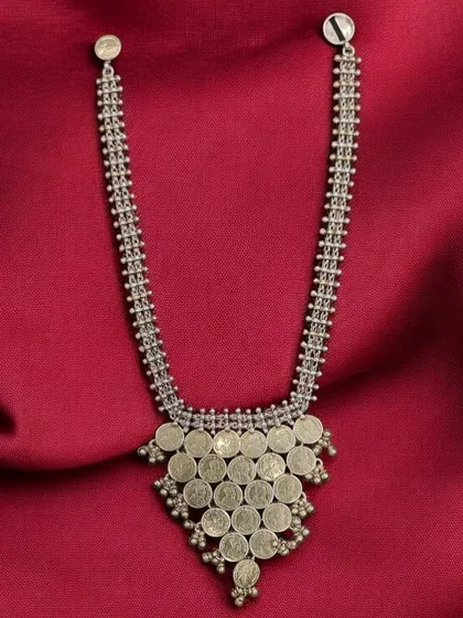 A classic coin necklace in oxidised silver. This design, known as a "kasu mala," is a timeless piece of traditional Indian jewellery.