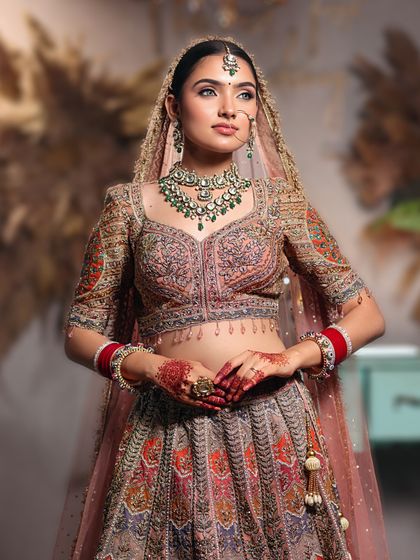 A full-length view of this magnificent bridal lehenga, showing how our makeup and styling create a cohesive and royal look.