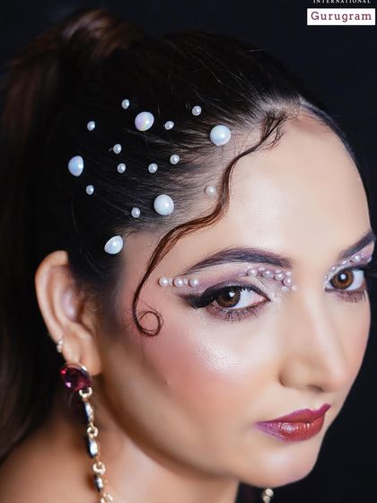 This detailed shot highlights the intricate pearl work along the hairline and brow. This is a technique often seen in high fashion editorials and runway shows.