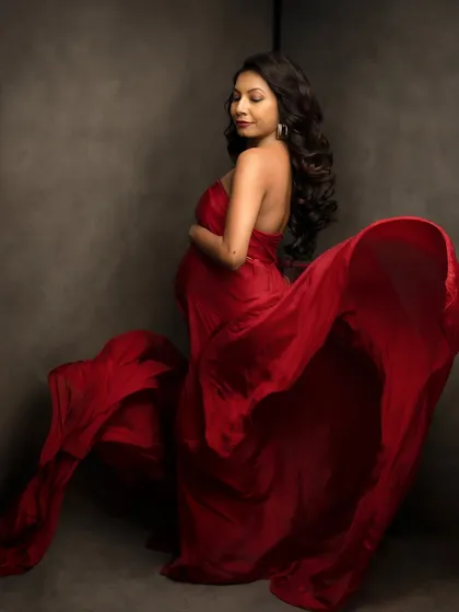Let's create some drama. The flow of fabric, the power of a bold color, and the beautiful silhouette of your body creating life. These artistic maternity portraits are for celebrating your strength and the sheer artistry of this journey.