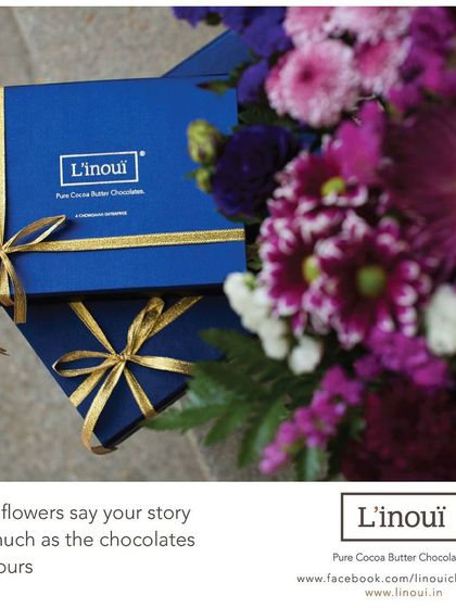 We believe flowers tell a story just as much as our chocolates do. This image showcases our ability to create stunning gift combinations for any celebration, pairing vibrant flowers with our elegant blue chocolate boxes.