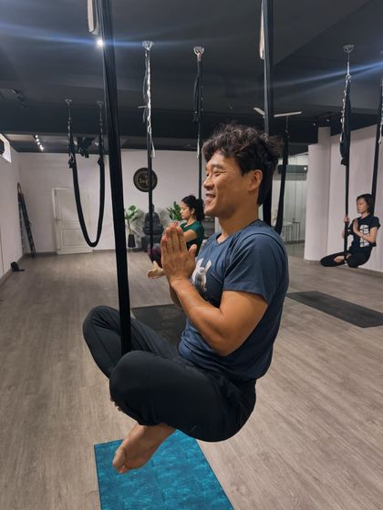 The joy of flight is visible on this student's face as he finds his balance and smiles, perfectly capturing the positive atmosphere of our studio.
