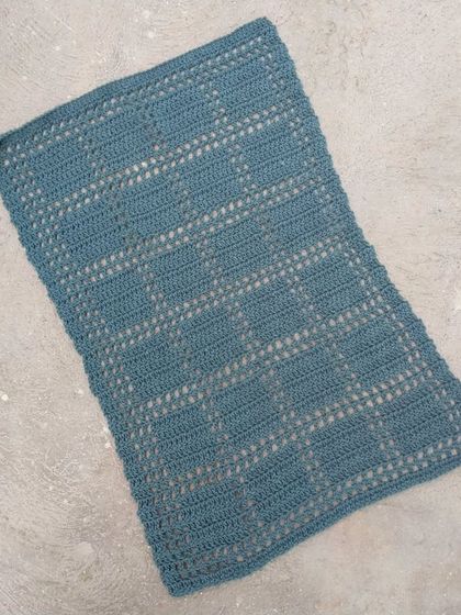 A table mat with a delicate checkered pattern.