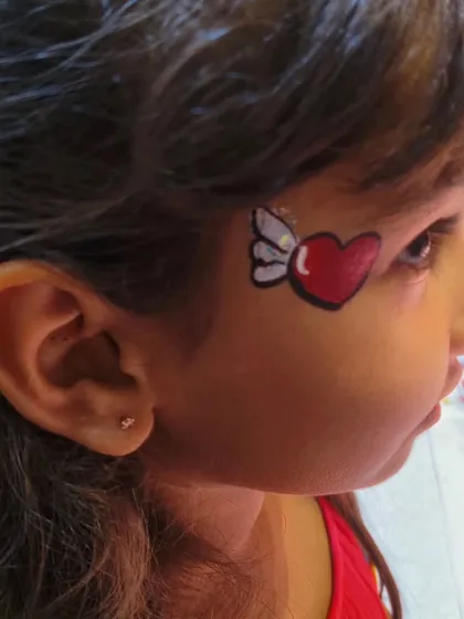 A clear view of the winged heart face paint design, a simple yet charming option that kids love.