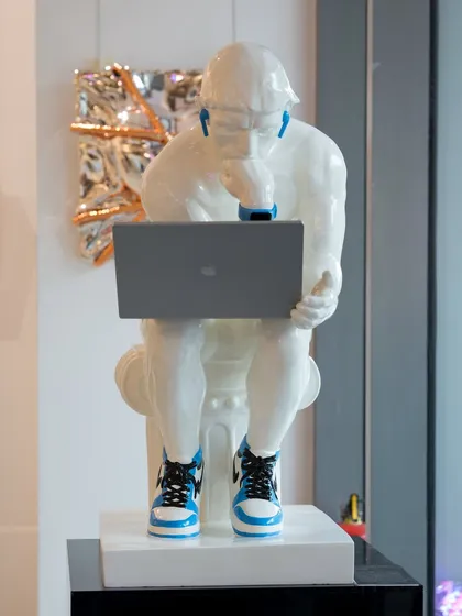 I took Rodin's "The Thinker" and brought him into the 21st century. Outfitted with a laptop, earbuds, and Nike Jordans, this fibre installation, "The Thinker's Resolve," fuses classical contemplation with contemporary hustle, reflecting the dynamic, inventive spirit of today.