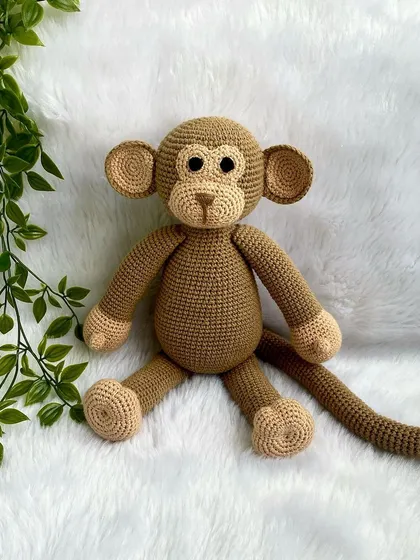 A playful monkey with a long tail, perfect for swinging around. This is my own custom design, and he's ready for lots of jungle adventures.
