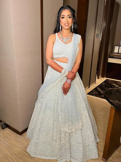 The classic smudged and smokey look for Sanskriti, perfectly complementing her shimmering silver ensemble for her reception.