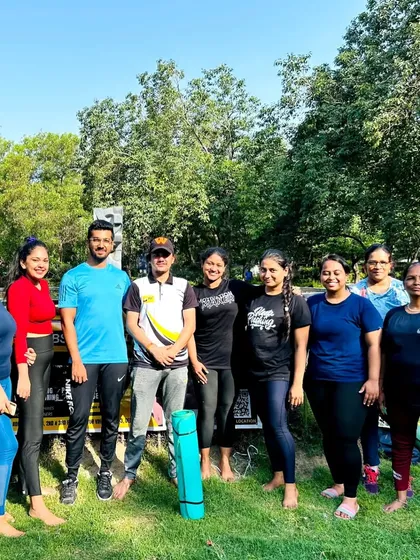 Another happy group from our outdoor yoga community. Join us to start your day with positive energy.