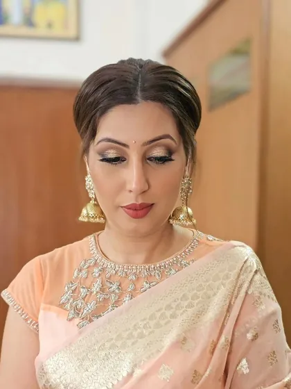 A close-up of Prerna's makeup, featuring dramatic winged eyeliner and beautiful gold jhumkas.
