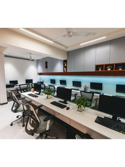 Another perspective of the open workspace, showing the clean lines of the custom storage units and the bright, even lighting that creates a productive environment for our team.