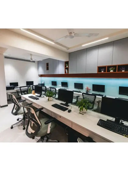 Another perspective of the open workspace, showing the clean lines of the custom storage units and the bright, even lighting that creates a productive environment for our team.