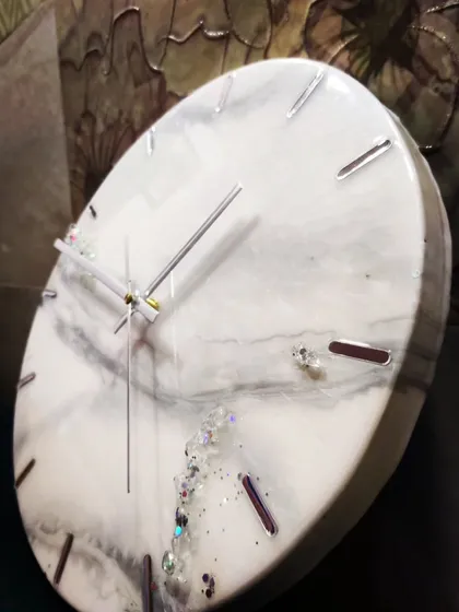 A 12 inch clock in a similar grey, silver, and pearl white combination, showing how each piece is unique.