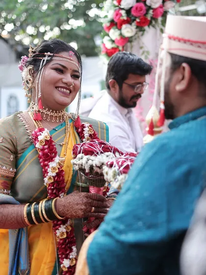 A beautiful interaction between the bride and groom. The bride's makeup is soft and romantic, perfect for these intimate moments.