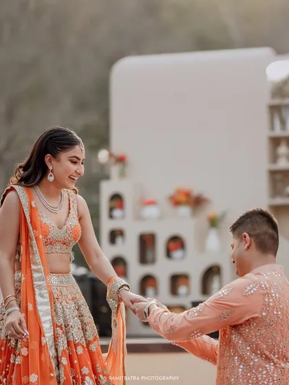 The groom-to-be takes his bride's hand during their beautiful outdoor engagement ceremony.
