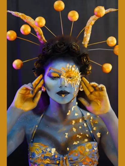 Another pose from the celestial shoot, showing the full effect of the headpiece and the gold leaf details.
