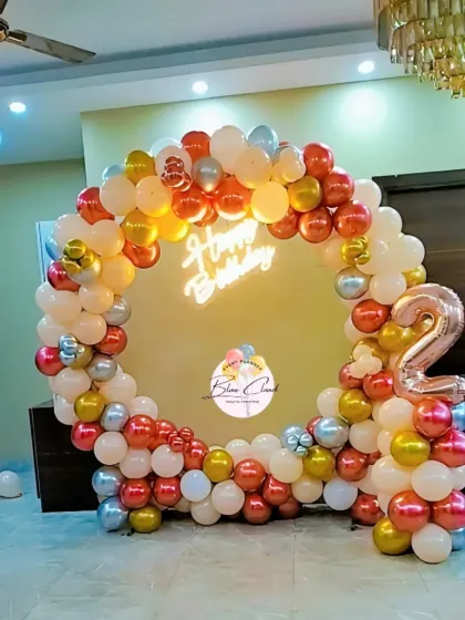 A warm-toned balloon ring in chrome red, peach, and gold for a second birthday.
