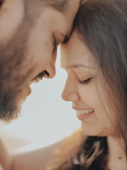 A tight, emotional close-up of Anushka and Manu, captured in soft, natural light. My focus is on capturing these gentle moments of affection that feel authentic and unposed.