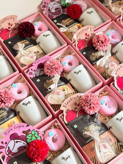 The contents of our pink baby birthday return favors are fun and thoughtful. Each box contains a cute mug, coffee concentrate, a personalized cookie, a donut soap, and a face sheet mask for a little pampering.
