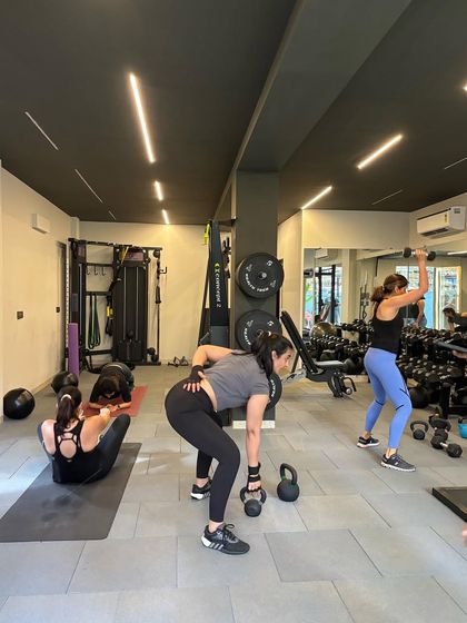 A snapshot of a small group training session in full swing. Everyone is focused on their own exercise but united in the energy of the room.