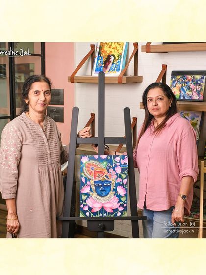 A student and I stand beside her beautiful, intricate painting of a deity, a piece she completed with dedicated effort in my fine art class.