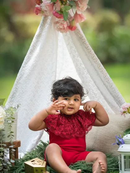 Such a playful expression! The teepee gives little ones a fun space to explore during their photoshoot.