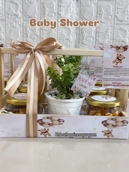 A beautifully lit shot of a teddy bear themed baby shower favor, highlighting the "Watch me Grow" tag and the elegant presentation.