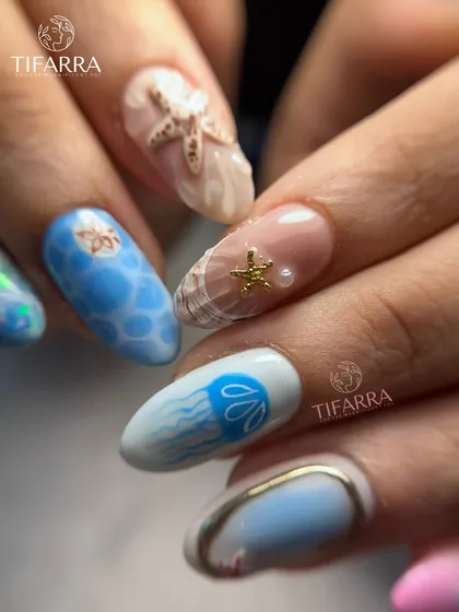 A view of the hand-painted jellyfish and 3D seashell nails from our intricate ocean-themed set.