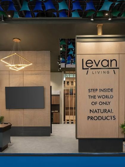 The entrance to the Realply pavilion features massive, veneer-clad volumes that create an impressive sense of scale. The clean lines and natural material finish communicate a message of quality and substance.