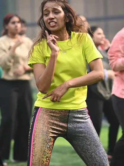 Our choreography services extend beyond weddings to corporate wellness and fitness events. This shot from a high-energy outdoor Zumba session shows how we get large groups moving, making any event fun, engaging, and full of positive vibes.