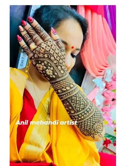 A client showcasing her intricate full-arm mehandi. The design is packed with traditional patterns and has a beautiful dark stain.