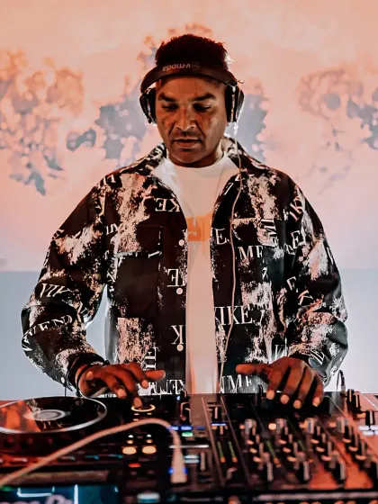 At the controls, mixing live on my Pioneer setup. This shot captures my focus during a high-energy set, ensuring every transition is seamless.