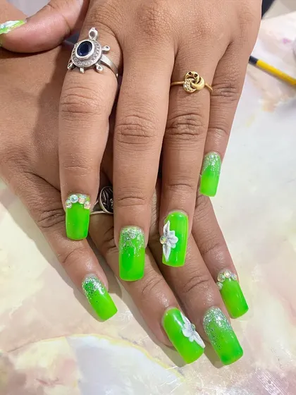 A neon green set that's sure to turn heads. The design includes a glitter ombre effect, 3D white flowers, and rhinestone details for extra sparkle.