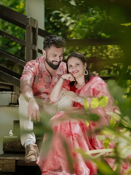 A duplicate of 275, showing a sweet, intimate moment on a wooden staircase, framed by green leaves.