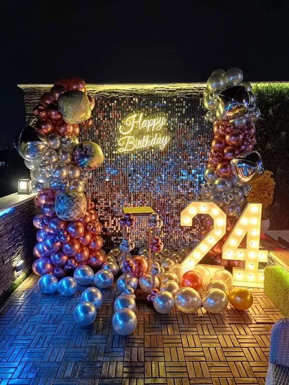 A full view of the glamorous shimmer sequin wall setup for a 24th birthday, perfect for photos.