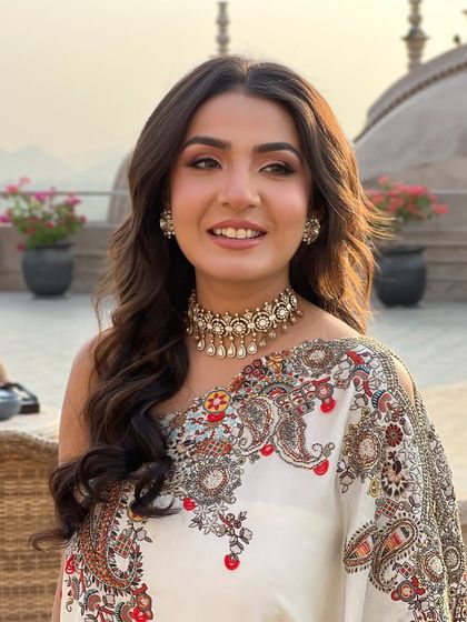 A portrait of the bride, her soft waves and natural makeup creating a fresh and elegant look.