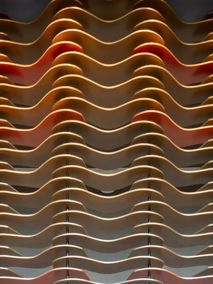 A close-up detail of the modular MDF facade at the Godrej South Estate Experience Centre. The contrasting colors and layered forms create a sense of depth and rhythm.