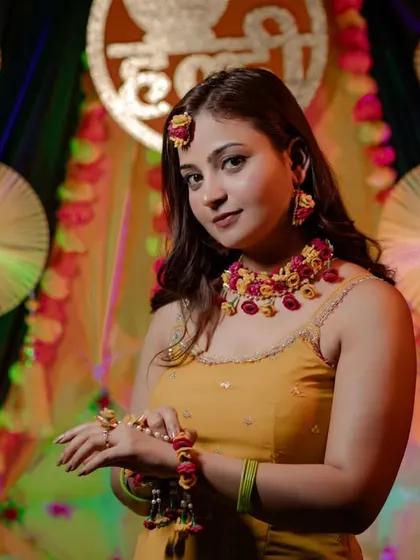 A beautifully lit portrait of bride Nidhi against her Haldi backdrop. We use professional lighting to make our brides look their absolute best.